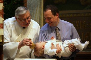 Deacon Henry Baptizes Baby Chase on Palm Sunday